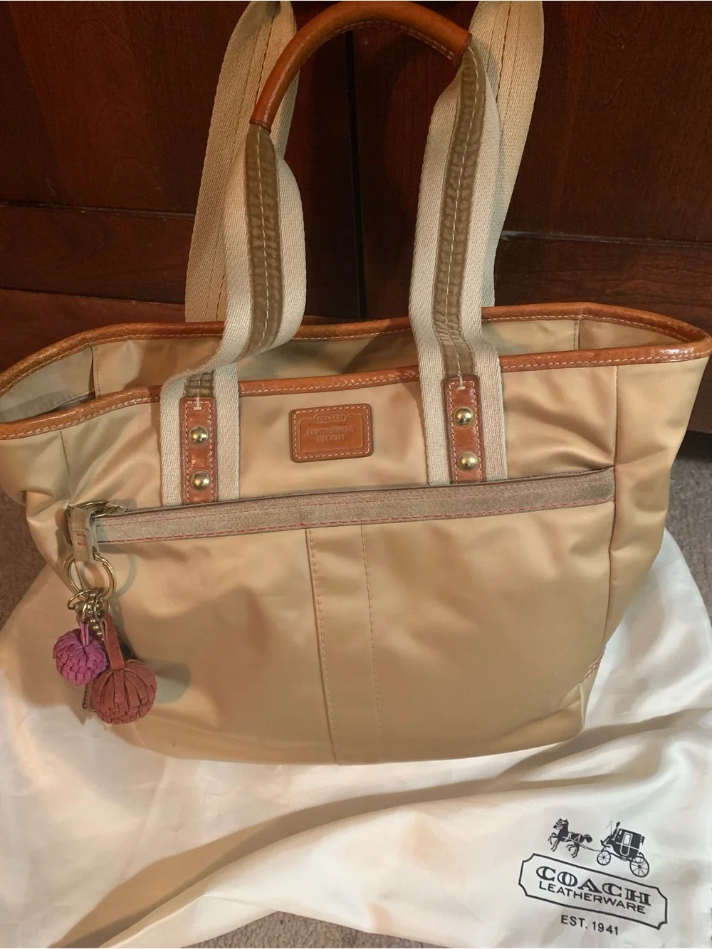 Coach Beige Tote with Tan Leather Trim and Pink/Burgundy Pom Charms